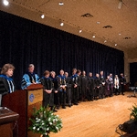 President Emeritus Haas and faculty members lined up on stage